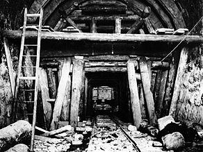Tunnel shaft supported by a wooden retaining structure. Tunnel shaft supported by a wooden retaining structure.