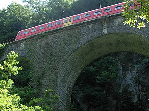 A train passing the Springquell Viaduct with three arches. A train passing the Springquell Viaduct with three arches.