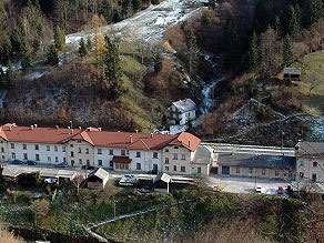 The elongated Podbrdo railway station with several buildings containing apartments today. The elongated Podbrdo railway station with several buildings containing apartments today.